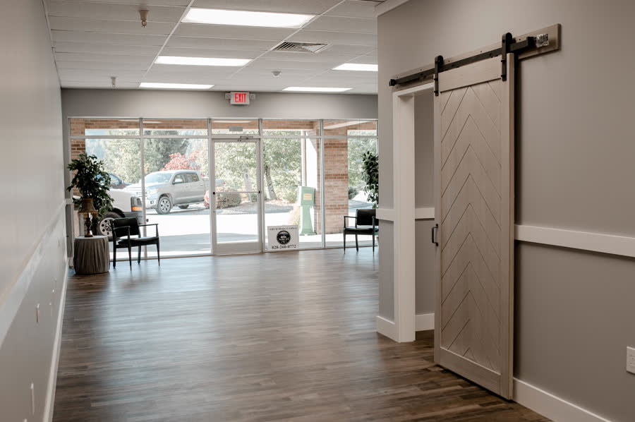 Commercial office build-out with sliding barn door and storefront lobby