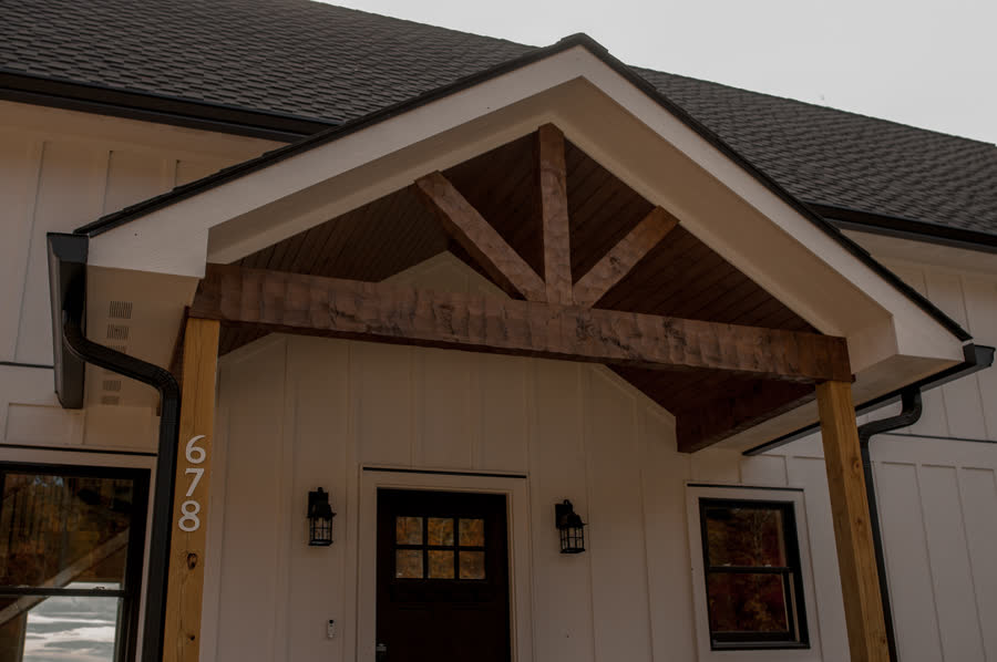 Timber-truss entry portico on a custom mountain farmhouse