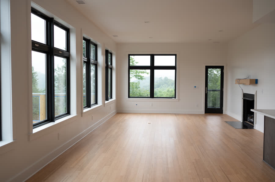 Window Wall Mountain Home living room with a wall of windows overlooking the mountains