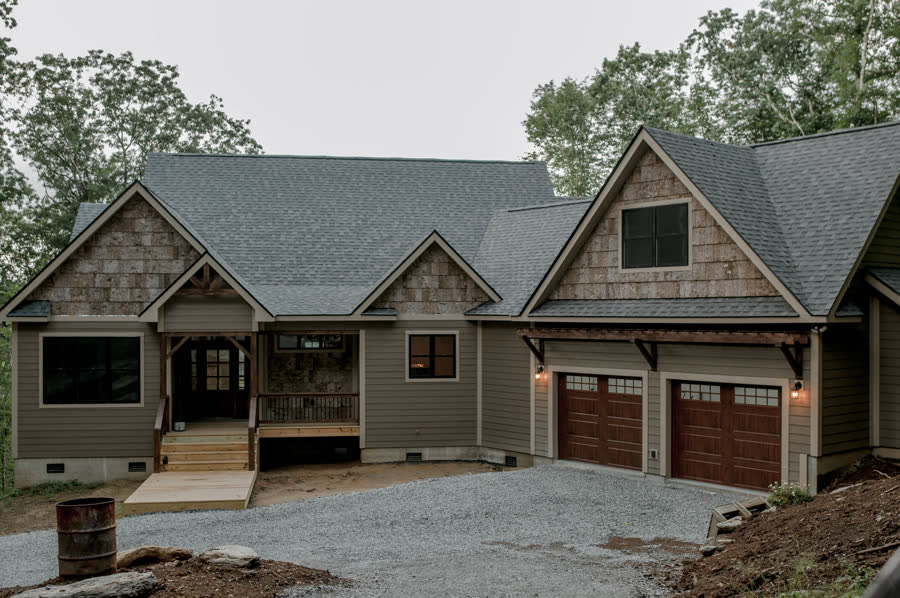 Craftsman-style custom home with cedar shake gables and timber detail